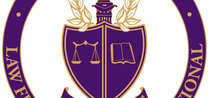Phi Alpha Delta logo. Purple circle and shield with gold letters.
